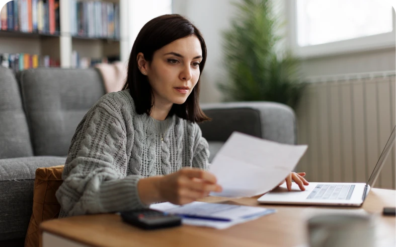 Individual focused on paperwork indoors