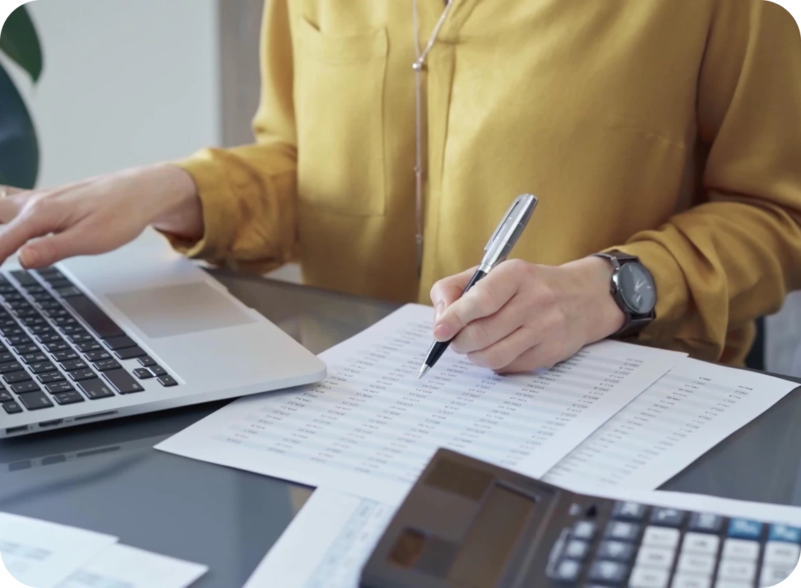 Woman analyzing financial documents at desk