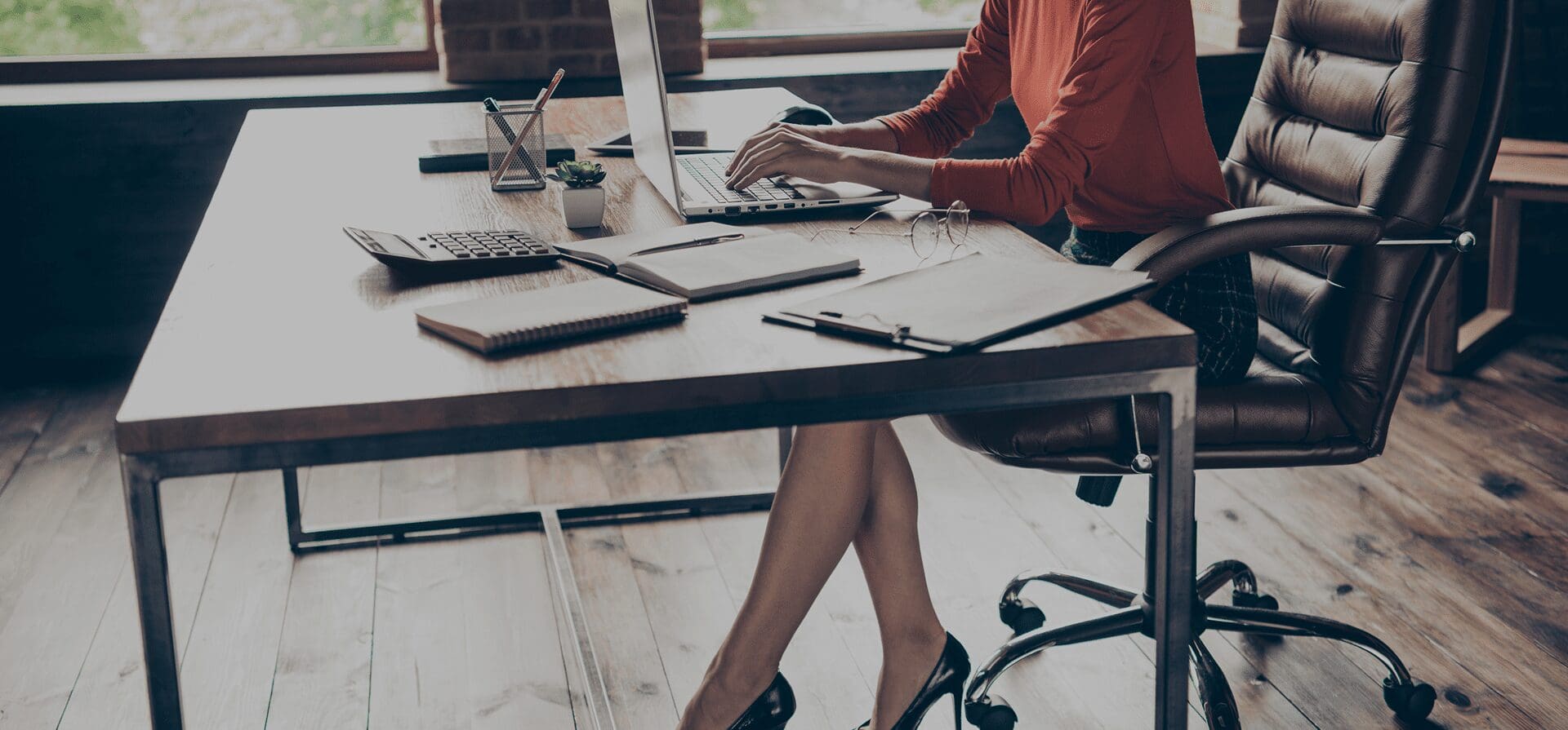 Woman working at a desk with laptop