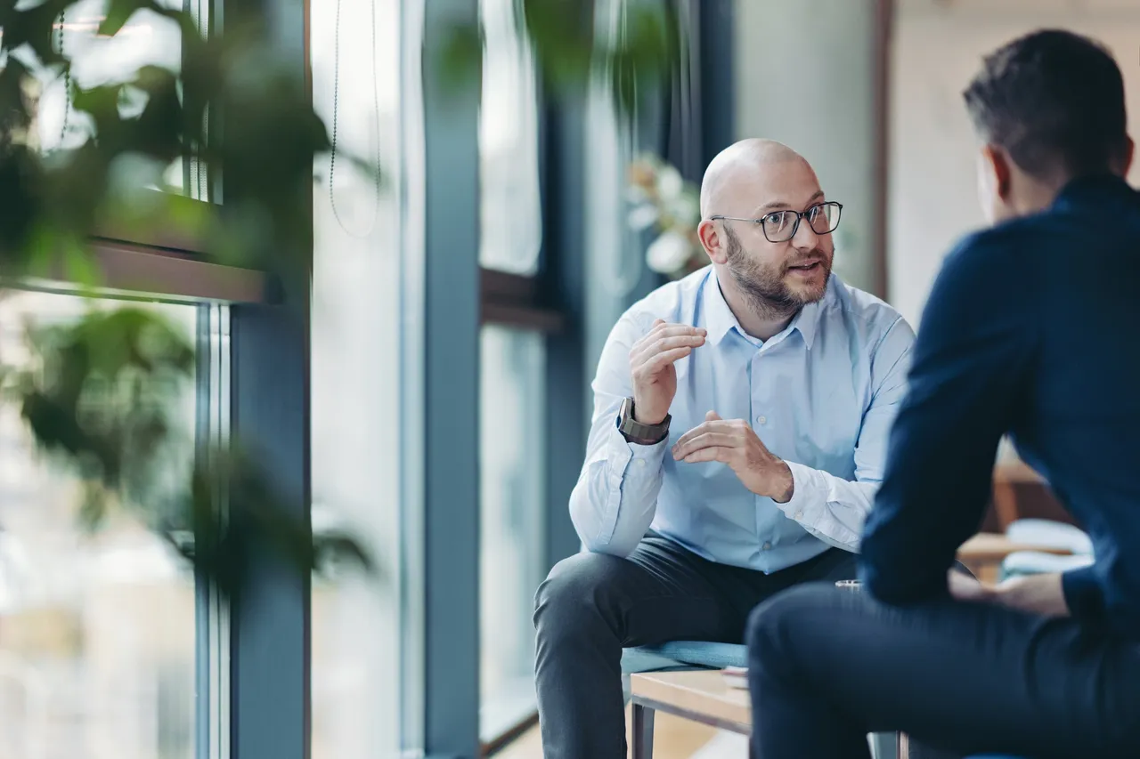Colleagues talking in a modern office