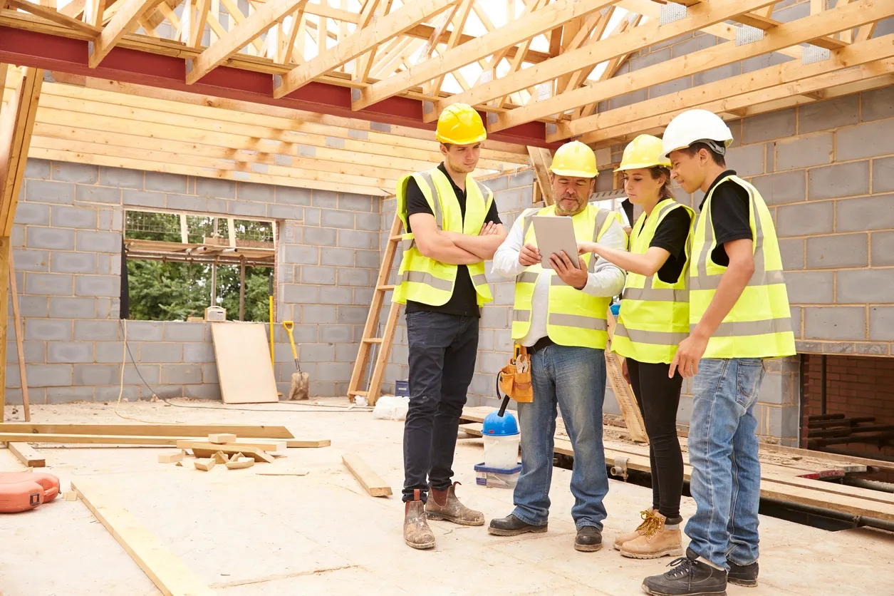 Builders wearing hard hats and vests